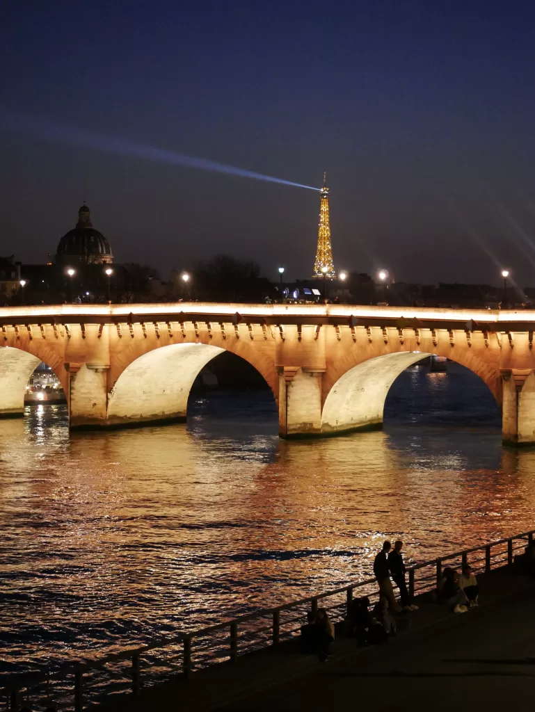 The Eiffel Tower sparkling in the night.